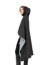 Model wearing a multicolored blue and grey blanket cape, showcasing its silhouette and hood