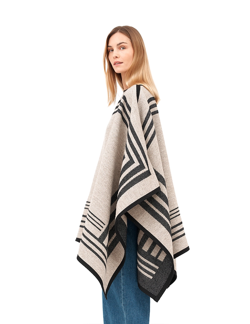 Beige wool reversible poncho with draped silhouette.