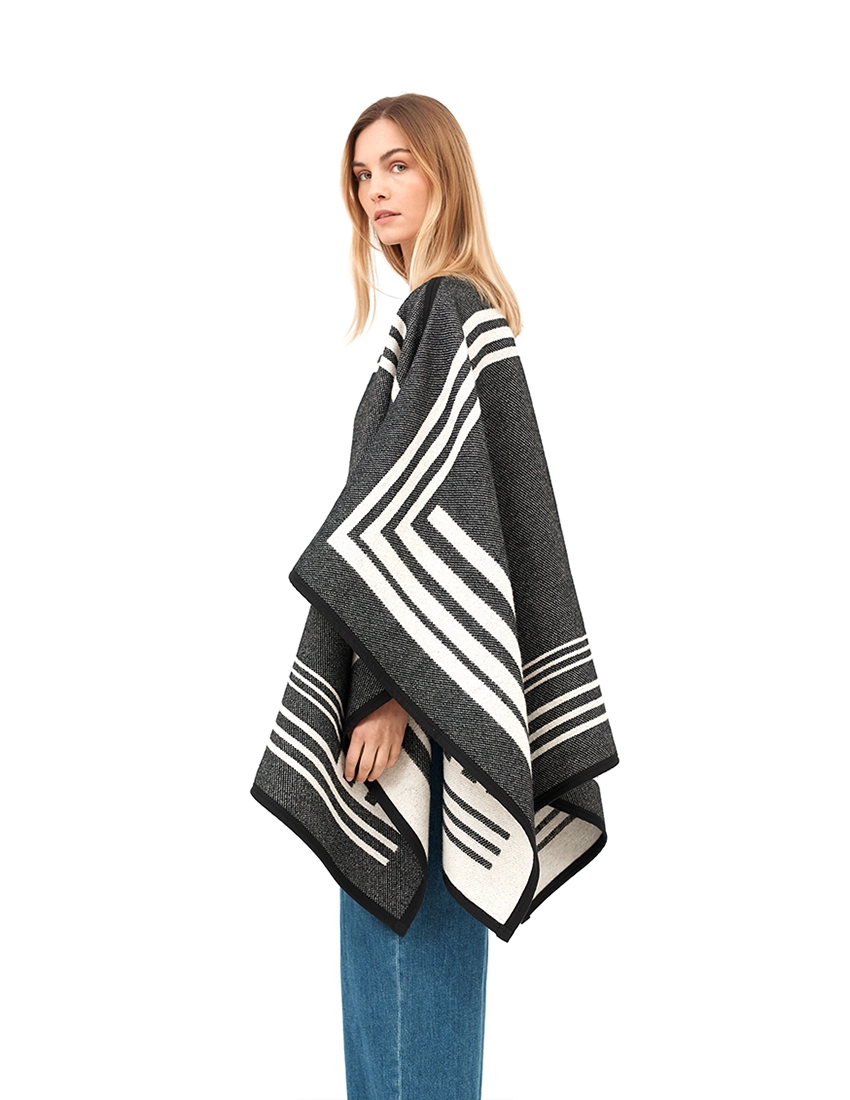 Black and white reversible poncho with a bold black exterior.