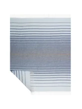 Full view of a striped recycled wool blanket laid out, showcasing its blue and white stripes and fringe on a white background.